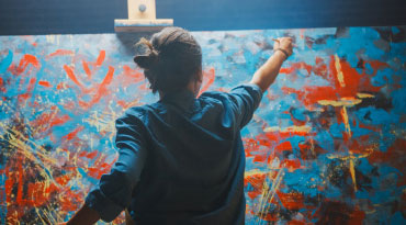 artist painting on a canvas