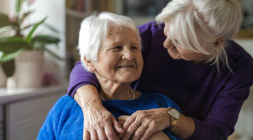 elderly person receiving an embrace